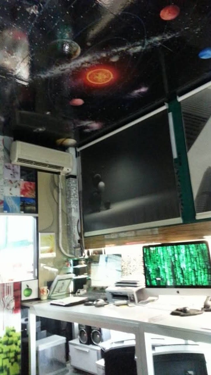 A workshop corner with a space-themed ceiling and decorative panels near the workbench.